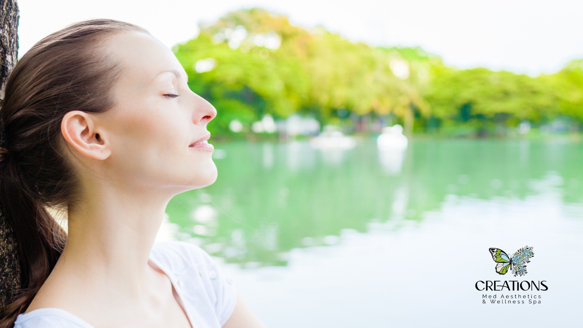 Woman meditating by a serene lake, promoting self-care and stress relief, with Creations Med Aesthetics & Wellness Spa logo.